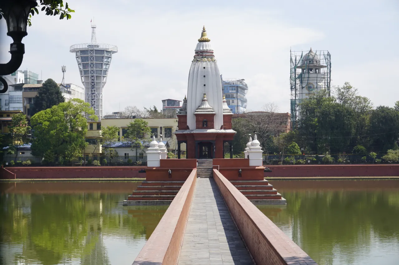 Picture of Rani Pokhari of Kathmandu with Bal Gopaleshwar Temple in the middle with Historical Ghanta Ghar and Modern Skywalk Nepal at backdrop
